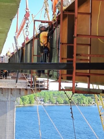 Installing the bolts on the splice plate connecting the girders