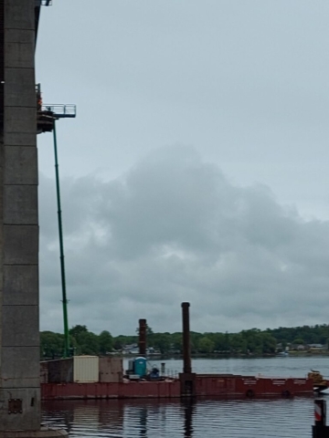 Using the man lift to saw cut the pier 11 deck soffit