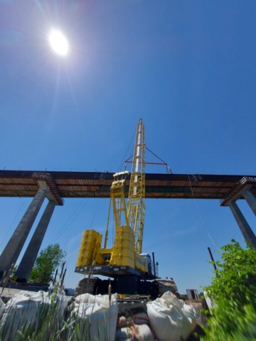 200 ton crane, drop-in girder lowered into place