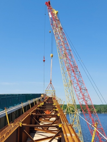 200 ton crane hooked up to the drop-in girder, 110 ton crane lowering materials for false decking