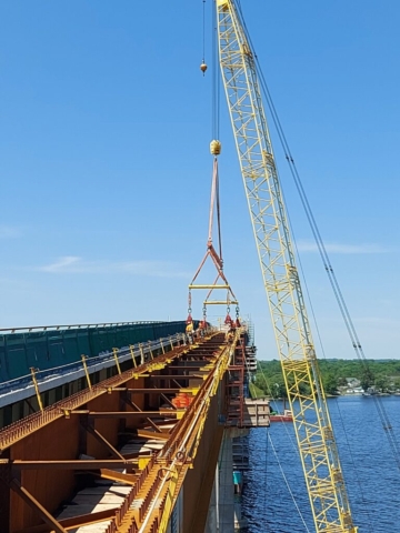 Releasing the spreader bar from the drop-in girder