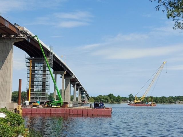 Using the man lift on the barge to install the brackets for the work platform