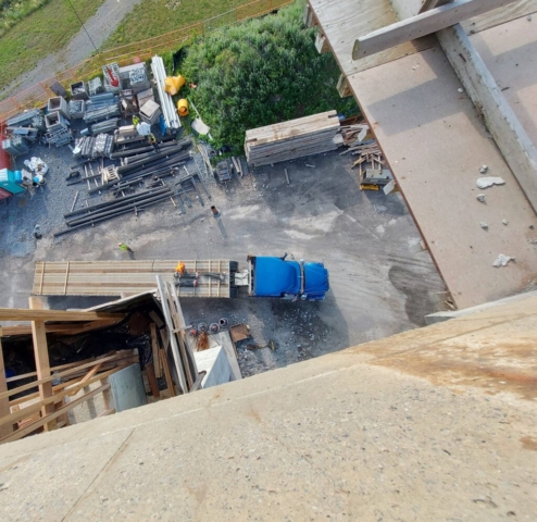 Top view of rebar being removed from the truck using the crane