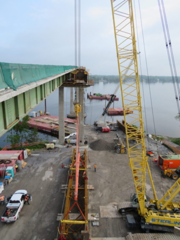 Installing spreader bars on the second approach girder, telehandler preparing crane pad, moving the man lift barge