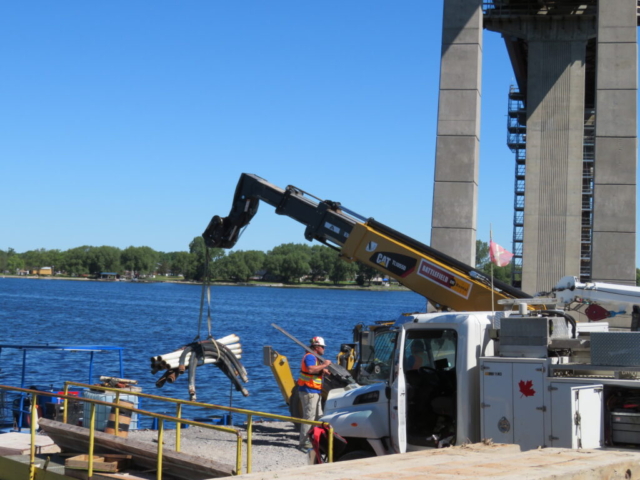 Loading the hoses for concrete placement onto the boat