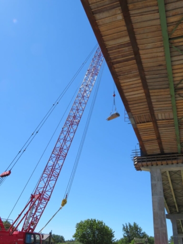 110 ton crane lifting wood to the deck for work platform installation