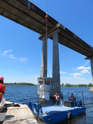 Loading the concrete onto the boat to be taken to the barge