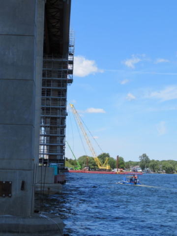 The boat taking the hopper of concrete to the barges for placement