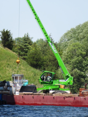 Lifting the hopper to the concrete pump with the man lift