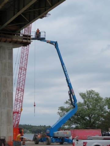 Using the Genie lift to install the brackets for the work platform