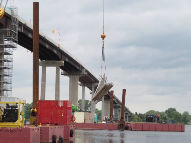 Moving the barges into place for bracket installation