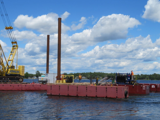 Moving the service barge into place for bracket installation