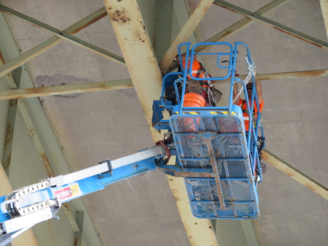 Using the Genie lift to access the existing girders