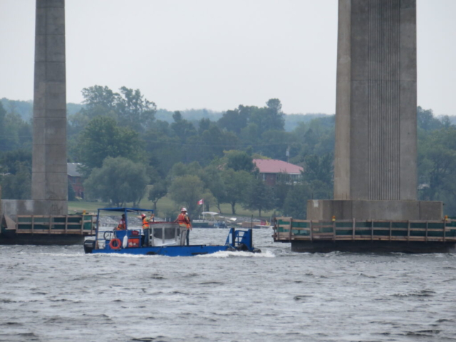 Transporting the concrete to the barge with the boat