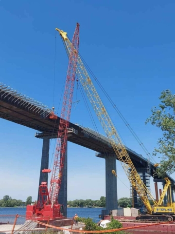 Expanded view of the 200 ton crane lifting the cage and the 110 ton crane lifting a bracket for installation