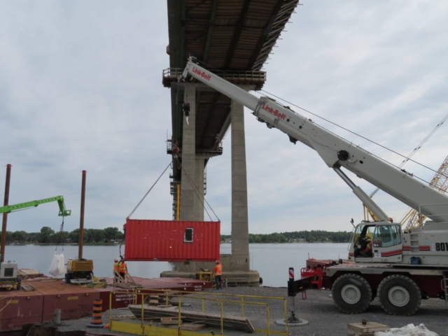 Loading the Sea-Can lunchroom on the barge with the telehandler