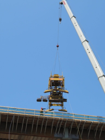 Lowering the concrete finisher onto the deck