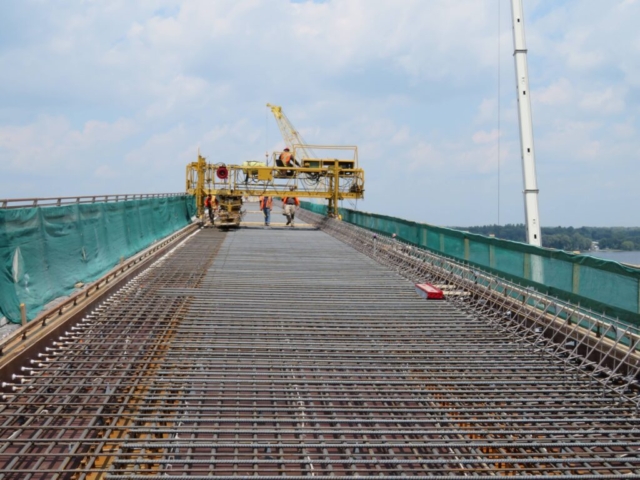 View north of concrete finisher in place on the screed rails