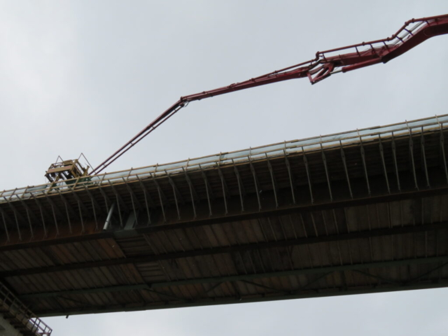 View from below of the concrete pump lifted to the  bridge deck