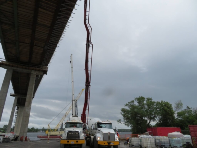 Overview from below of the bridge, concrete trucks and pump