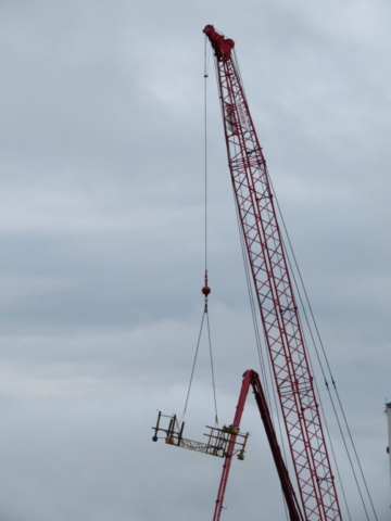 Lifting the work bridge to the deck with the 110-ton crane