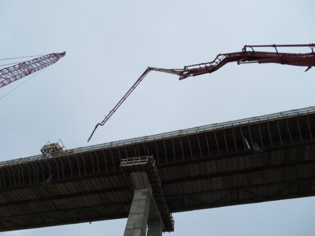 Lifting the concrete pump to the bridge deck in preparation for concrete placement