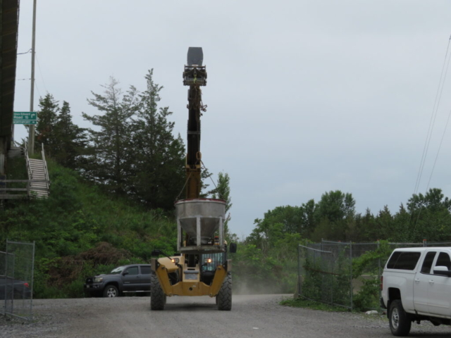 Telehandler delivering the hopper for concrete placement