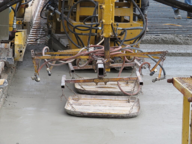 Close-up of the concrete finisher and newly placed concrete