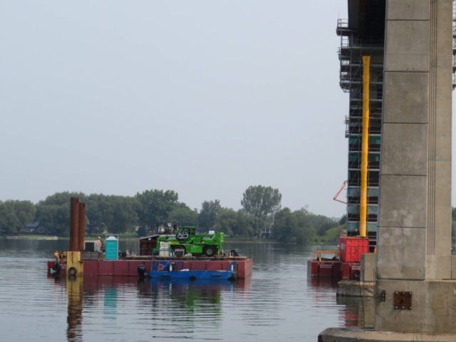 Moving the manlift barge  into place near pier 10