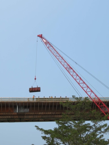 View from below of barrier wall formwork being lowered into place