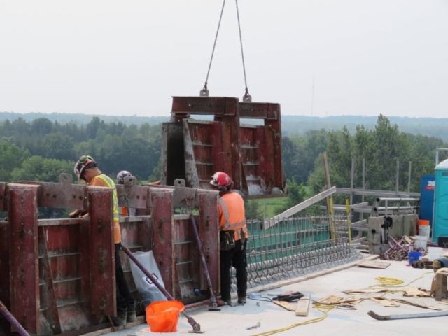 Top view of the barrier wall formwork being lowered into place