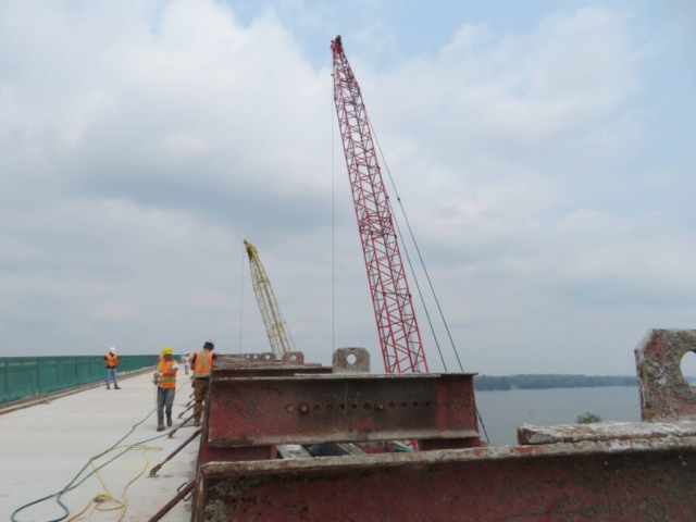 Barrier wall forms in place , both 110 and 200-ton cranes