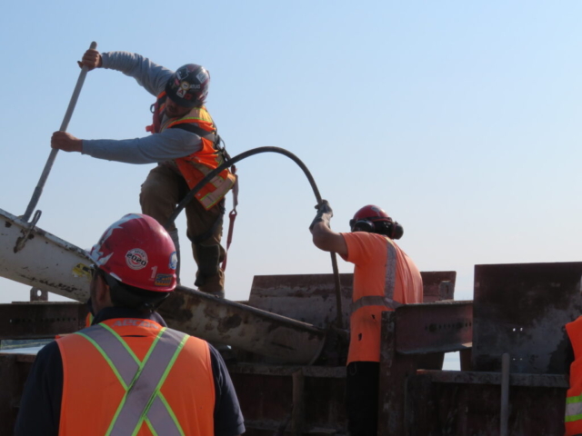 Filling the concrete forms, vibrating the concrete