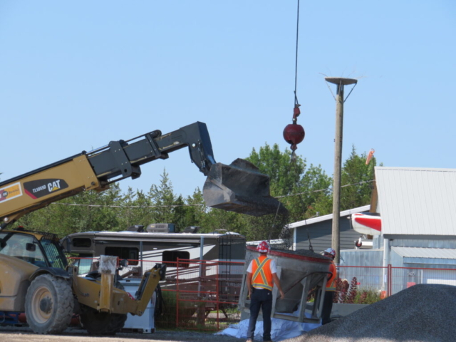 Using the telehandler to fill the hopper with granular