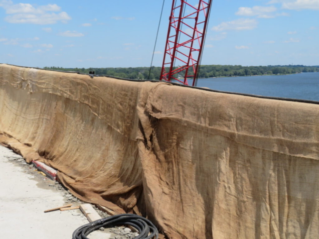 Wet burlap covering new barrier wall section