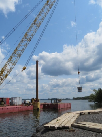 200-ton crane lifting the full hoppers to the barge