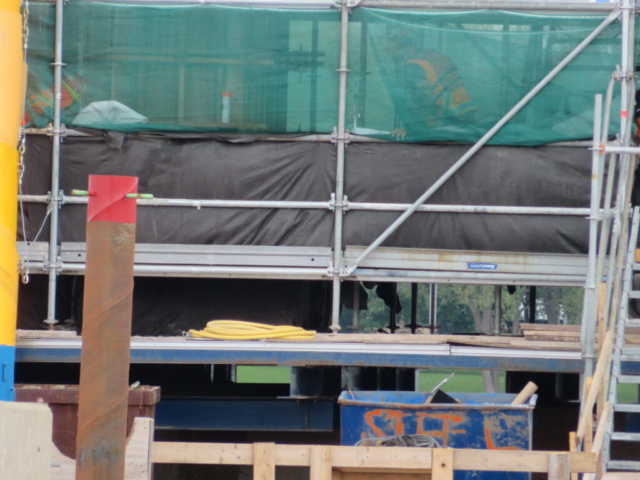 Looking through the containment netting to the formwork on pier 10