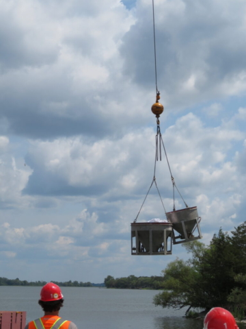 Empty hoppers being lifted back to the dock to be filled