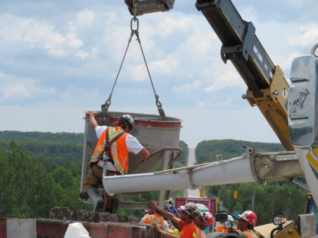 Lowering the hopper to the barrier wall formwork