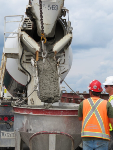 Filling the concrete hopper with the concrete truck