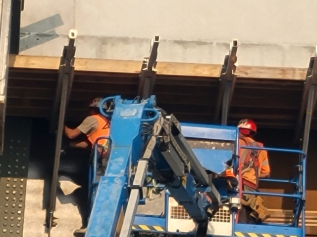 Close-up of the removal of  the work platform brackets