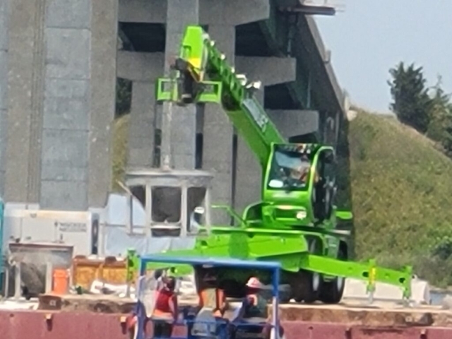 Removing the concrete filled hopper from the boat using the manlift