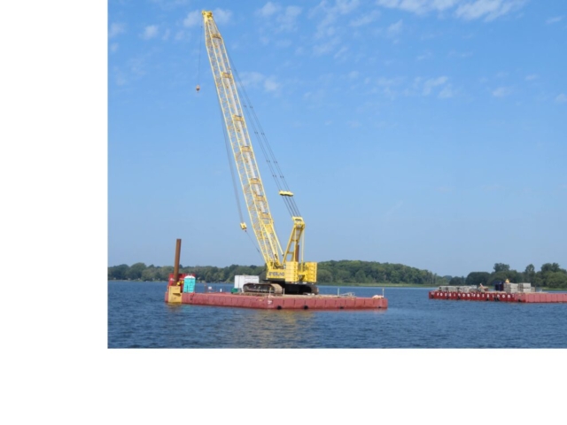 Moving the barge containing the containment scaffolding to the crane barge