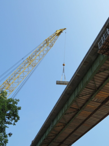 200-ton crane lowering materials to the bridge deck