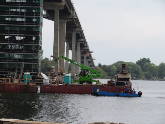 Concrete placement on pier 10, lowering hopper onto the concrete pump