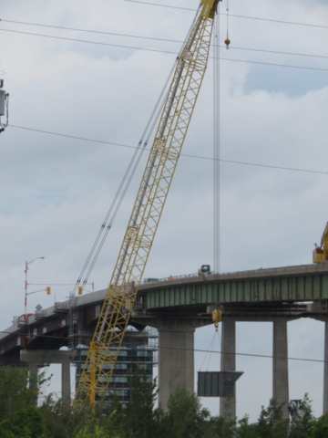 200-ton crane lowering the full containment bin to the barge