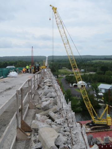 View south of the partially demolished barrier wall, 200-ton crane, containment bin