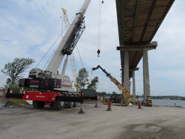 Using the telehandler to move the containment bin to the 160-ton crane, to be lifted to the deck