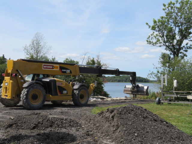 Using the telehandler to spread the granular