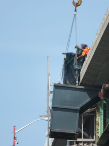 Putting the containment screens in place around the containment bin